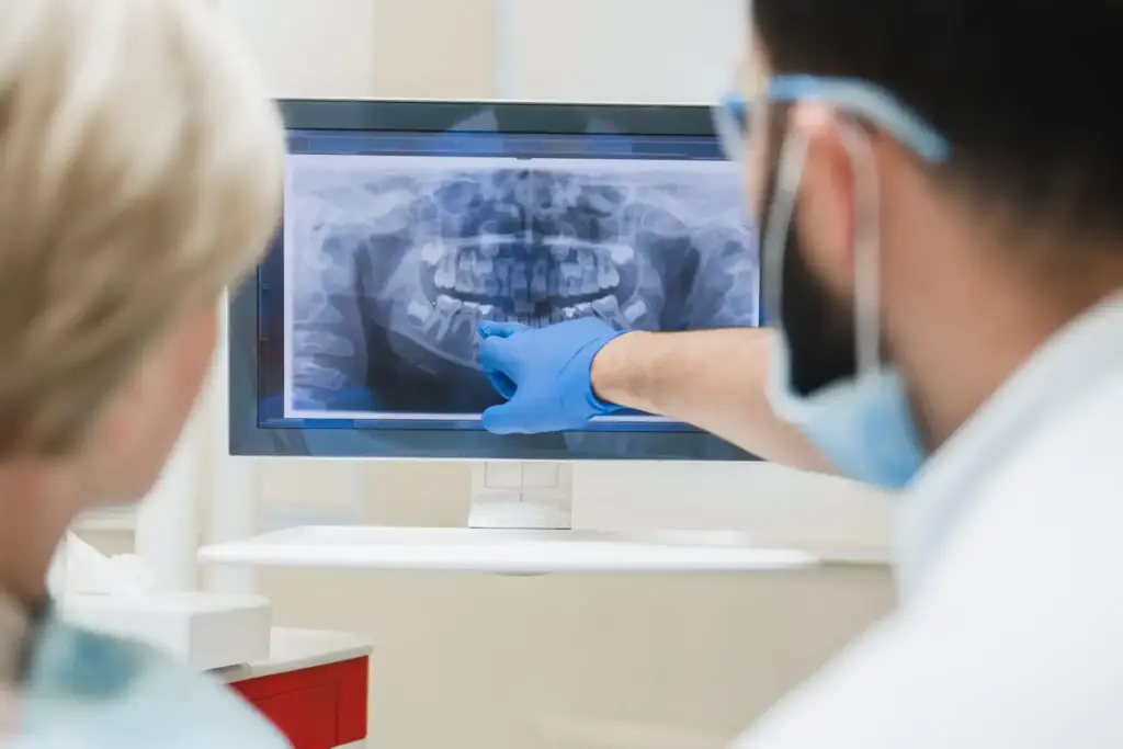 Dentist reviewing an X-ray on a practice workstation