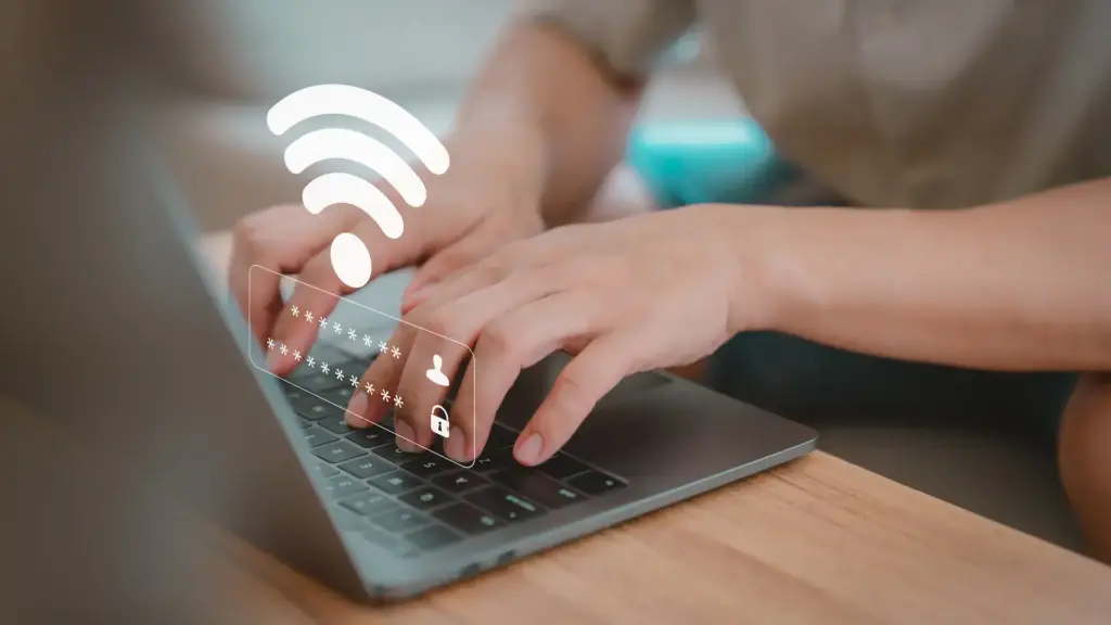 Hands on a laptop with a Wi-Fi signal